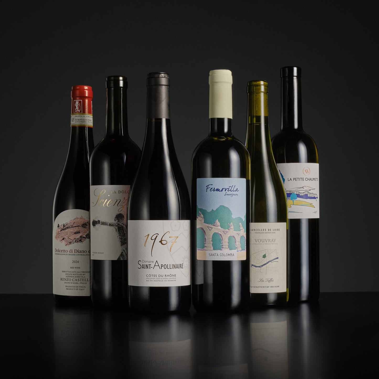 Collection of wine bottles with labels on a dark background
