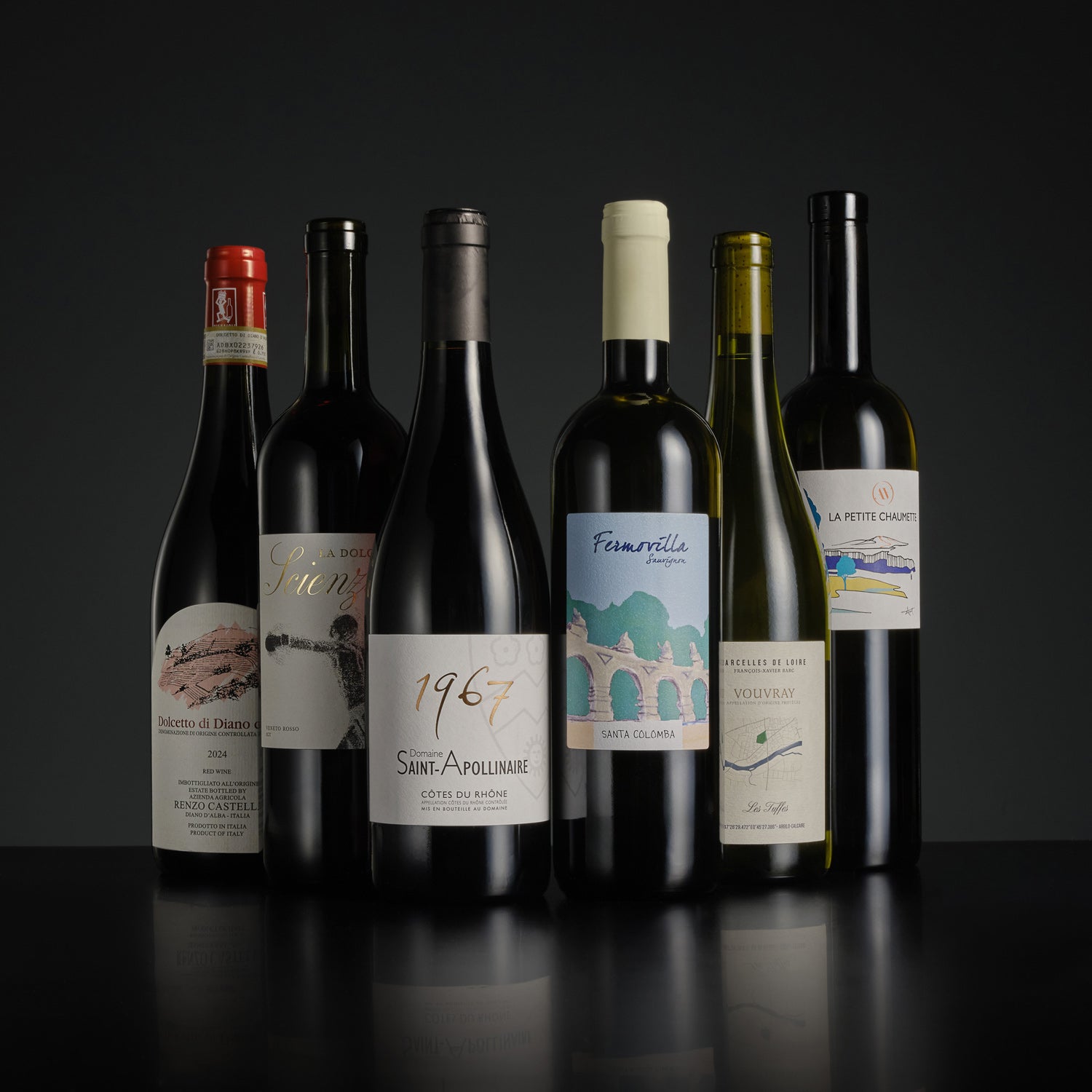 Collection of wine bottles with labels on a dark background