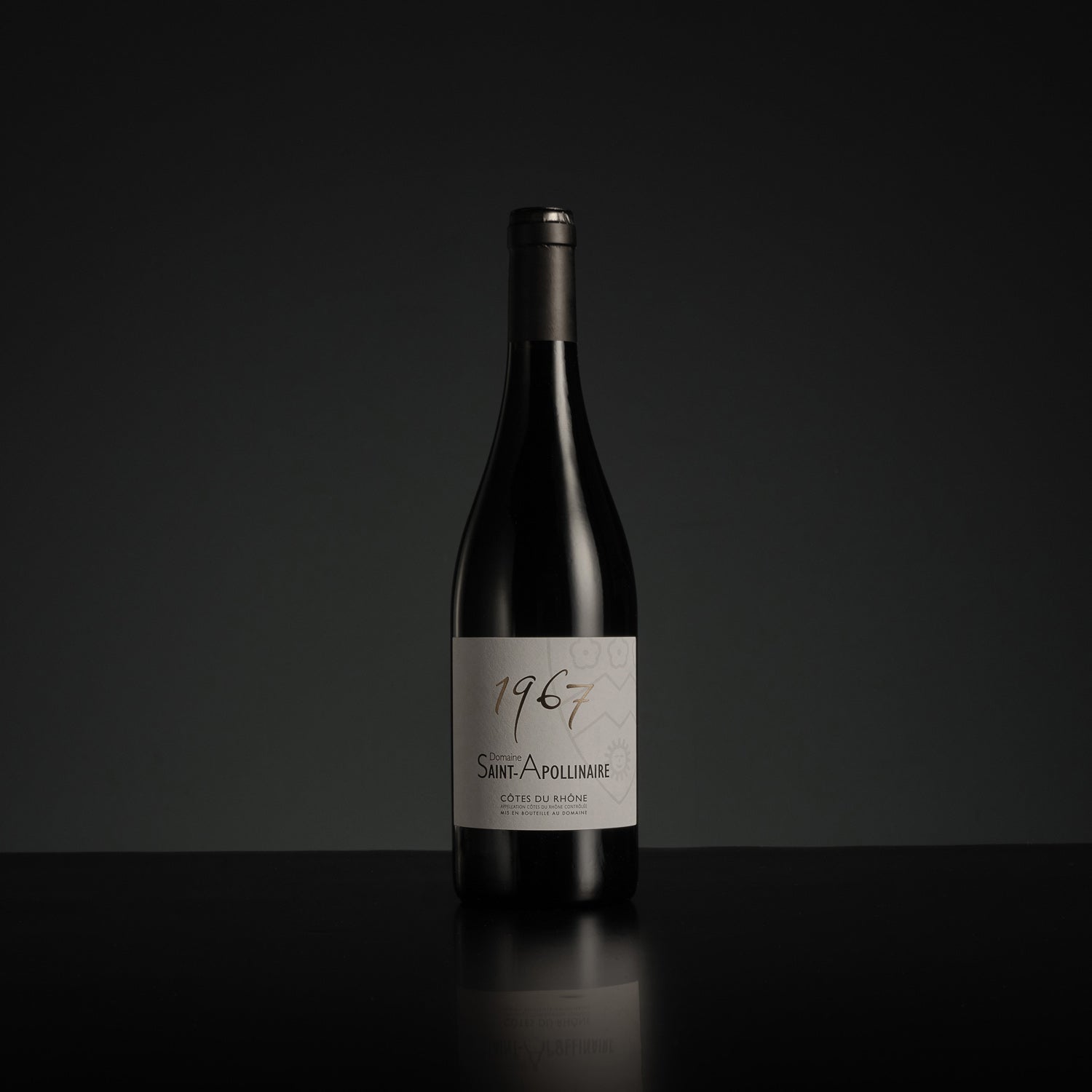 Wine bottle with '1967' label on a black background
