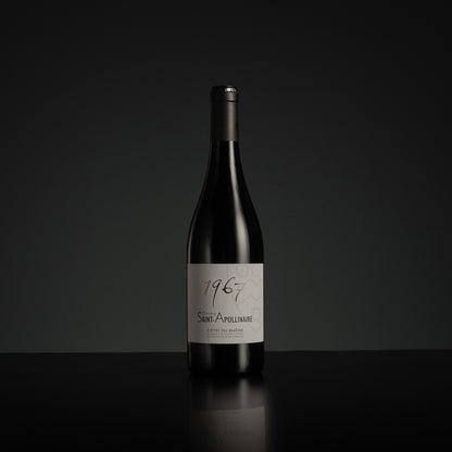 Wine bottle with '1967' label on a black background