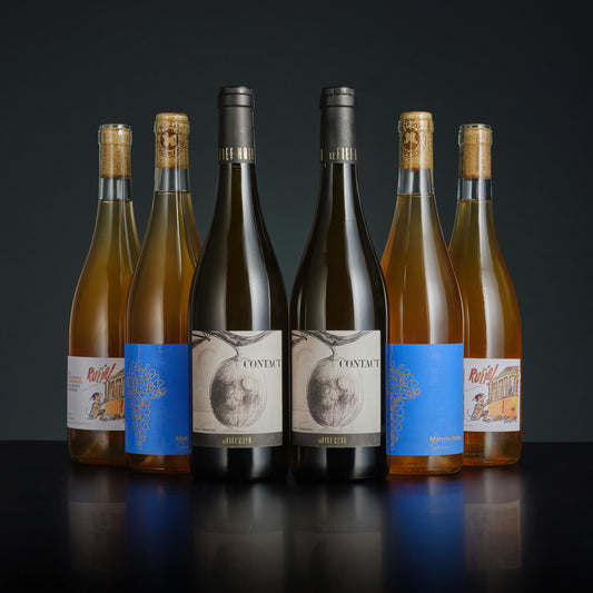 Set of wine bottles with labels on a dark background